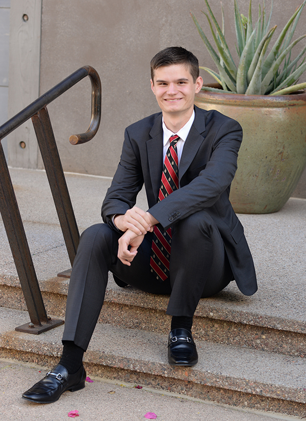 Picture of Bryce sitting in formal attire